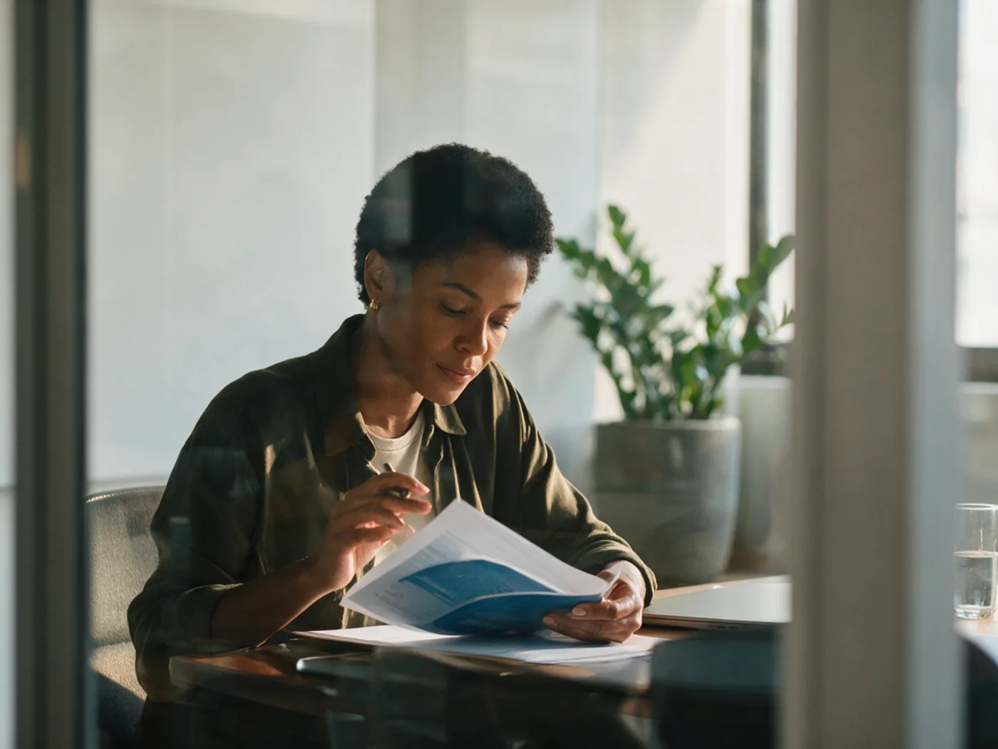 Professional reading a document carefully before approving the campaign.